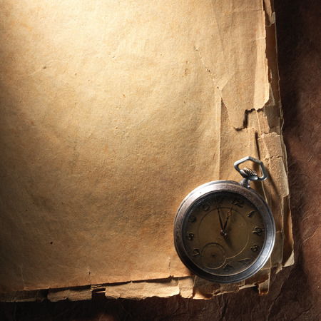 Vintage clock on the very old paperの写真素材