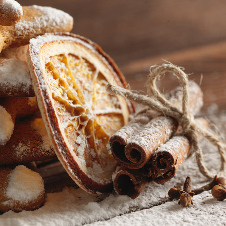 Christmas gingerbread cookies and spices on wooden background. Close-upの写真素材