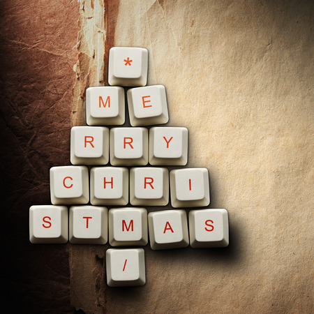 Christmas card - Christmas tree made of computer keys, Old paper backgroundの写真素材