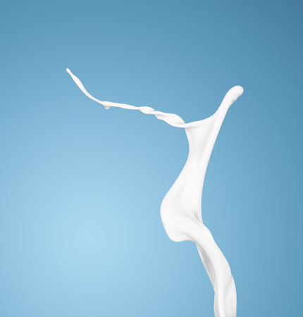milk or white liquid splash on blue background. isolatedの写真素材