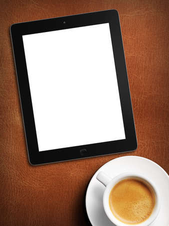 tablet white screen similar to  display and coffee on backgroundの写真素材