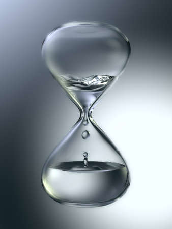 Hourglass with dripping water close-up. Gray backgroundの写真素材