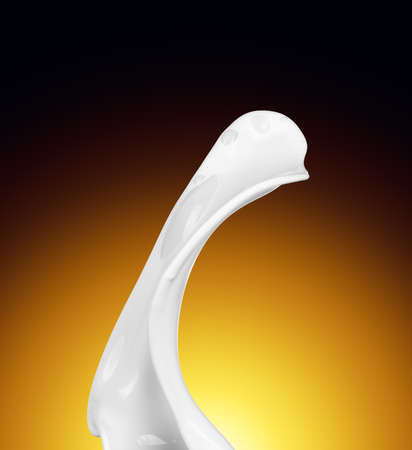 Splash of white fat milk as design element on yellow and brown backgroundの写真素材