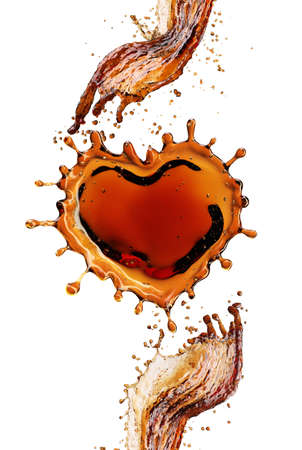 Heart from cola splash with bubbles isolated on white backgroundの写真素材