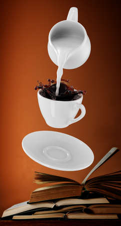 Milk being poured into small cup of coffee. 3d renderingの写真素材