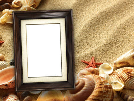 Pictue frame on shells and sand background. Copy space.の写真素材