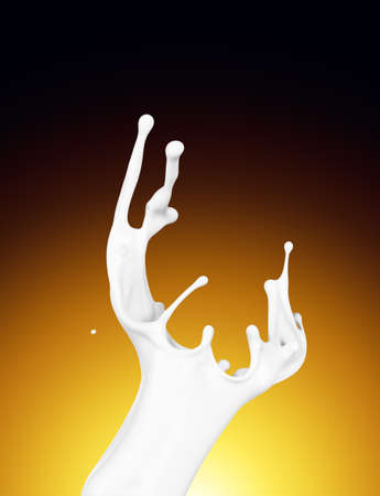 Splash of white fat milk as design element on yellow and brown backgroundの写真素材