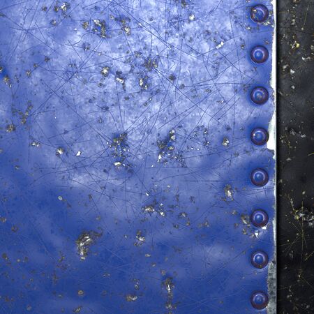 Painted blue metal with rivets on black metal background. 3d renderingの写真素材
