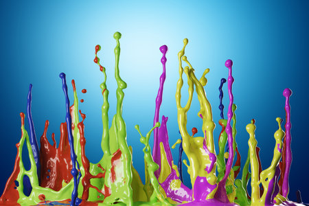 Colored paint splashes on blue backgroundの写真素材