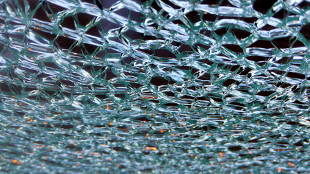Macro shot of the patterned glass partition that looks like an ice or frost with sparkling lights reflect on itの写真素材