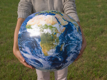 Woman holding earth ballの写真素材