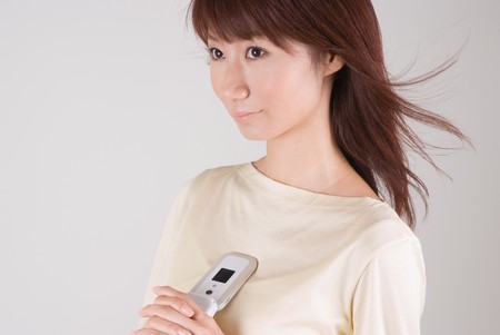 Young woman holding mobile phoneの写真素材