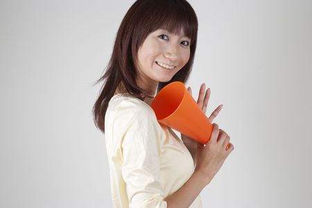 Young woman cheering with megaphoneの写真素材
