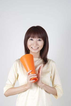 Young woman cheering with megaphoneの写真素材