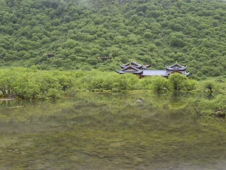 Temple reflected on surface of lake, Huanglong. Chinaの写真素材