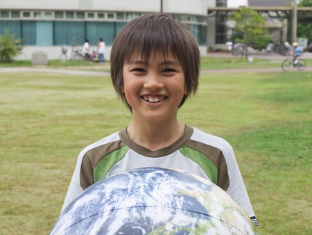 Boy holding globeの写真素材
