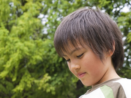 Portrait of a boy looking downの写真素材