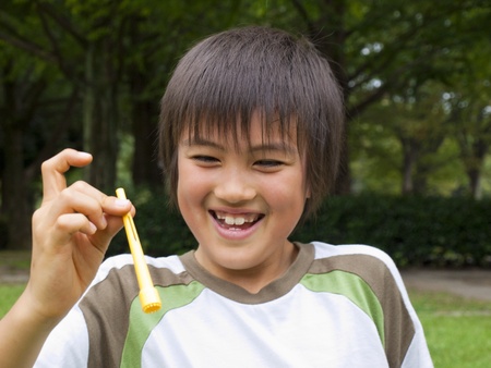 Boy playing with soap bubblesの写真素材