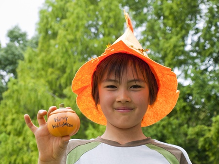 Boy holding halloween pumpkinの写真素材