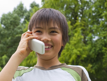 Boy talking with mobile phoneの写真素材
