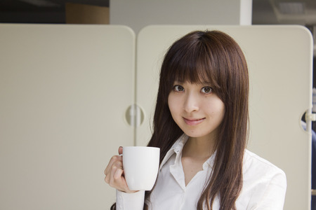 Business woman relaxed with a cup of coffeeの写真素材