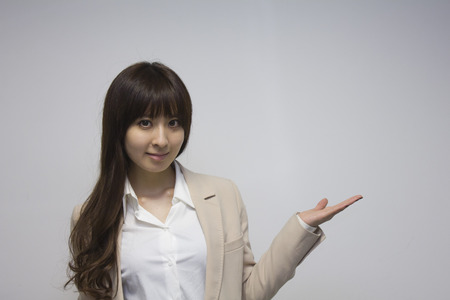 Business woman showing copy space with handの写真素材