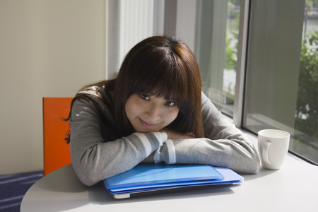 Young woman relaxed in officeの写真素材