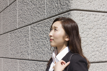 Young businesswoman looking upの写真素材