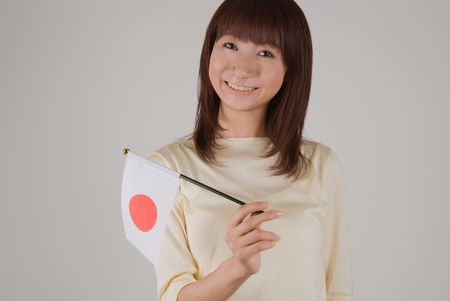 Young woman holding Japanese flagのeditorial素材
