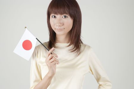 Young woman holding Japanese flagのeditorial素材