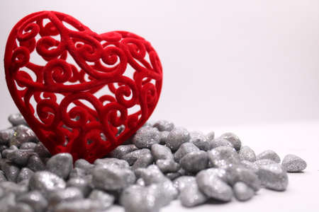 Valentine's Day concept background with red heart on gray stones with space for text. Background for the site, postcards, posters, banners.の写真素材