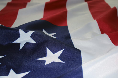 The flag of the United States, folded in waves. Flag Day. The concept of Independence Day,...