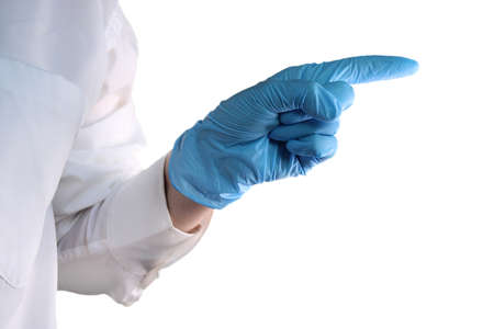 The doctors hand in a blue medical glove points the direction with his finger.の写真素材