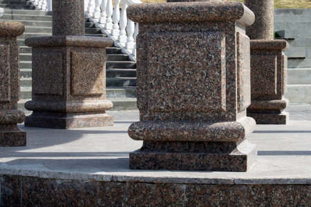 Large brown marble columns close-up on the background of the stairs in vintage style. Urban architecture. Tourism conceptの写真素材