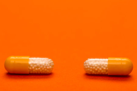 Color medical capsules text space on pink background