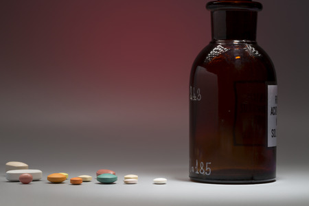 Glass medical bottle with copy space on a colorful backgroundの写真素材