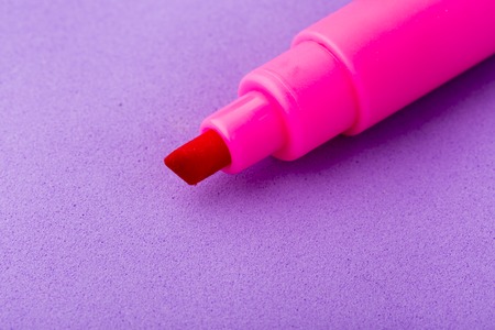 Single pink ink marker isolated on purple backgroundの写真素材