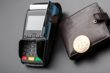 Bitcoin,bank POS-terminal and credit card.Over black background
