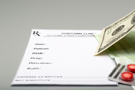 Blank prescription,blister pack of red pills and hundred banknotesの写真素材