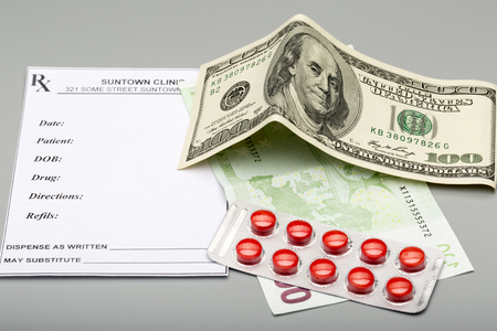 Blank prescription,blister pack of red pills and one hundred banknotesの写真素材
