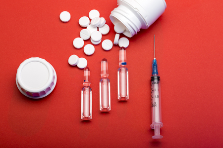 Disposable syringe for injection, ampoules, white round pills and pill bottlesの写真素材