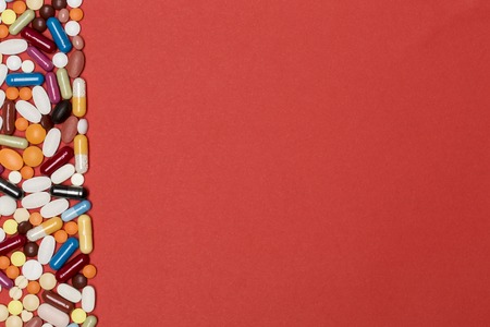 Blank page with border of multi-colored pills and capsules. Concept for the pharmaceutical and medical designの写真素材