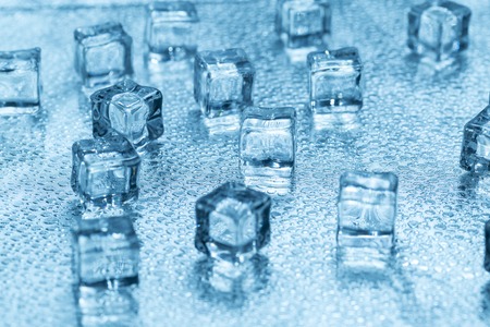 Many blue melting ice cubes on glassの写真素材