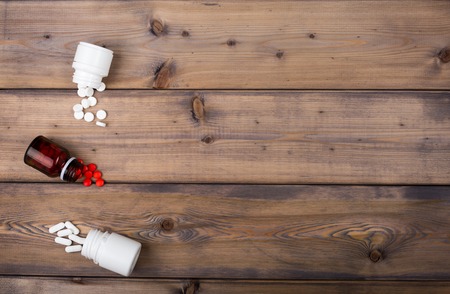 Setup from various pill bottles an blister pack on wooden tableの写真素材