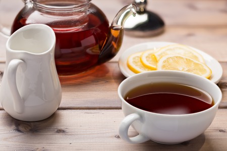 Glass teapot and teacup on wooden backgroundの写真素材
