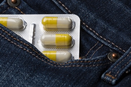 Blister pack of pills in jeans pocketの写真素材