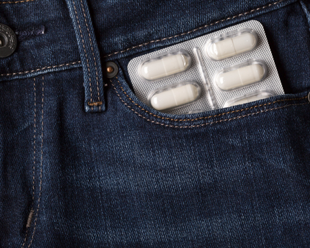 Blister pack of pills in jeans pocketの写真素材