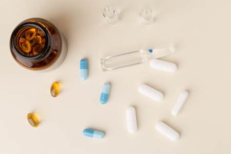 Bottle of pills from the brown glass and colorful capsulesの写真素材