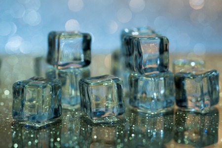 Group of melting ice cubes on glass tableの写真素材