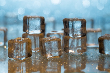 Group of melting ice cubes on glass tableの写真素材